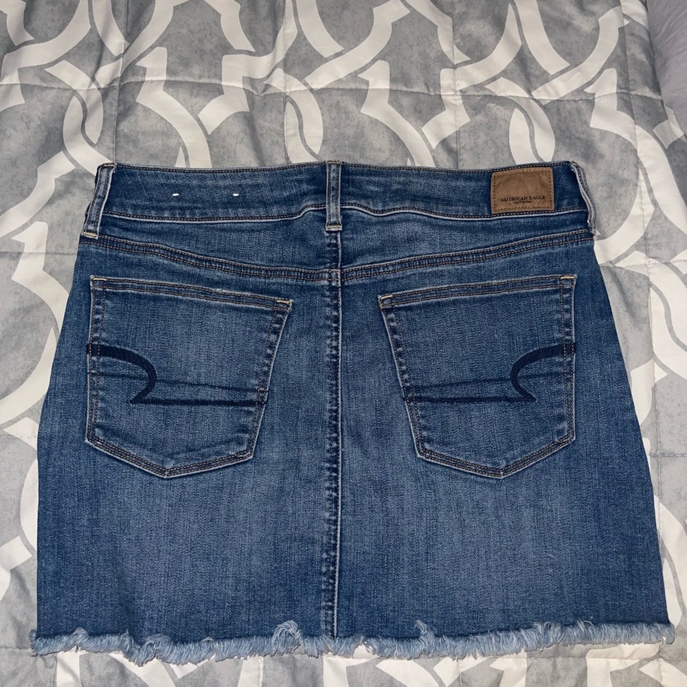 Distressed denim mini skirt.